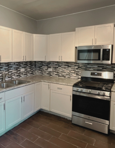 Kitchen remodel in Chicago with a white and natural wood cabinet combination.