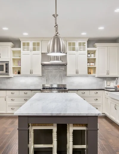 Luxury Chicago penthouse kitchen remodel with marble island and gold hardware accents.